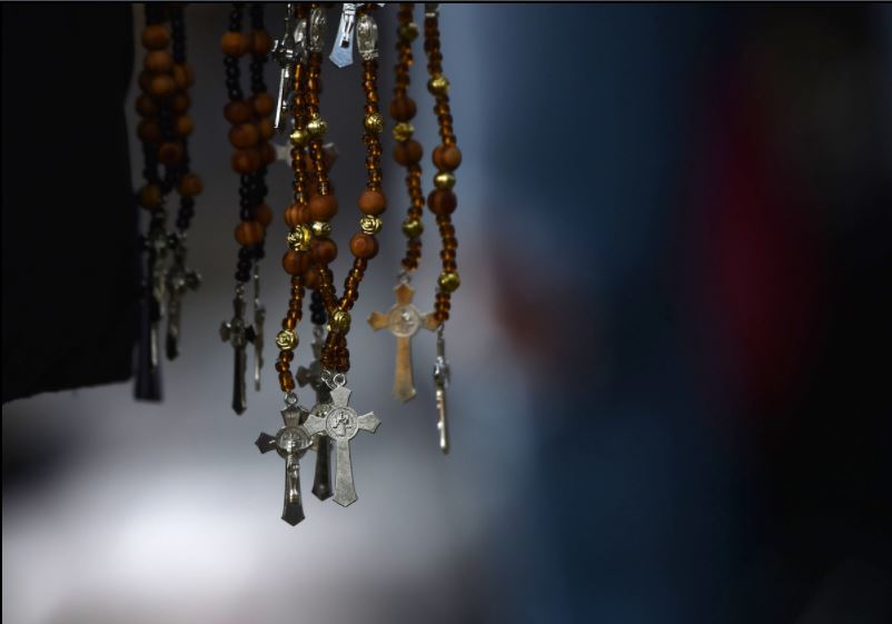 Rosaries are sold by a vendor in Mexico City