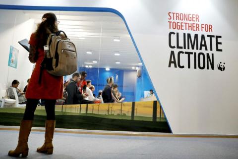 A woman watches an exhibition inside the venue of the U.N. climate change conference, or COP24, Dec. 8 in Katowice, Poland. 